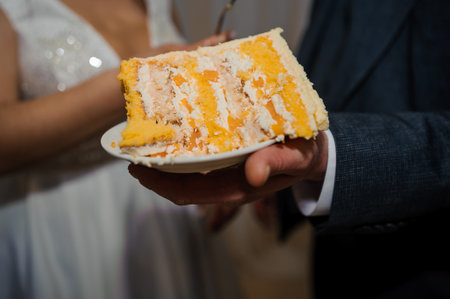 Deliciously Layered Wedding Cake Slice with Creamy Frosting Served on a Plate.の写真素材