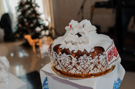 Elegant Traditional Cake Decorated with White Flowers and Festive Ambiance.の写真素材