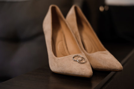 Elegant Wedding Attire Featuring Beige High Heels and Wedding Rings.の写真素材