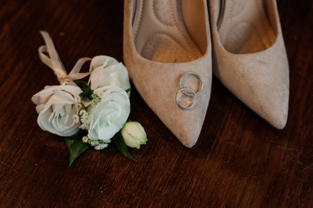 Elegant Wedding Details Featuring Bridal Shoes and Floral Arrangement.の写真素材