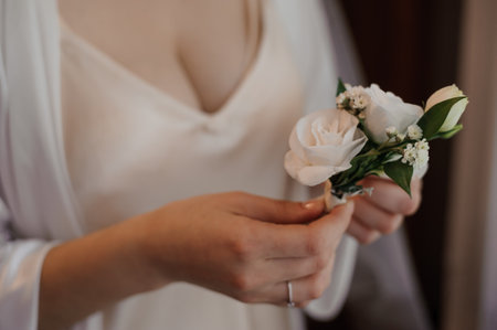 Elegant Bride Holding White Floral Boutonniere.の写真素材