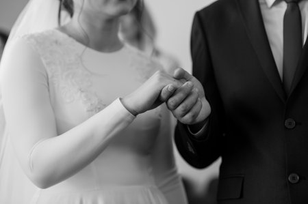 Elegant Black and White Wedding Ceremony with Joined Hands.の写真素材