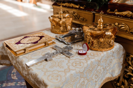 Ornate Wedding Table with Golden Crowns, Cross, and Sacred Book.