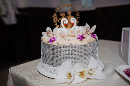 Elegant Wedding Cake Decorated with Flowers and a Topper.の写真素材