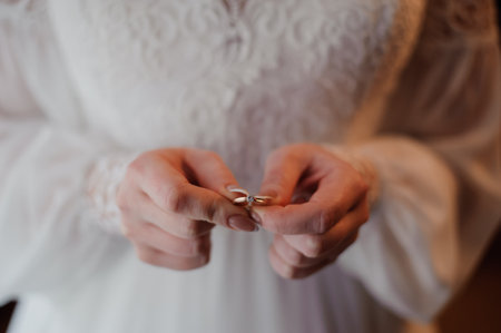 Bride Holding Wedding Rings Close-Up.の写真素材