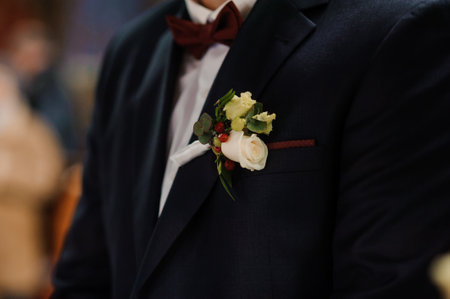Elegant Groom's Attire with Flower Boutonniere.