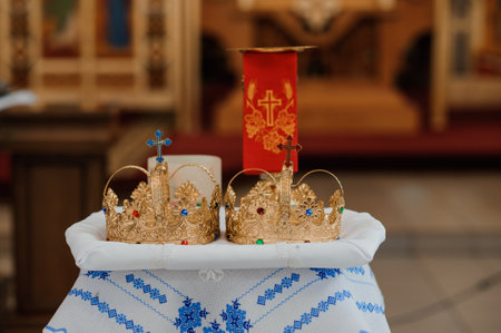 Ornate Golden Crowns on Decorative Tablecloth in Religious Setting.の写真素材