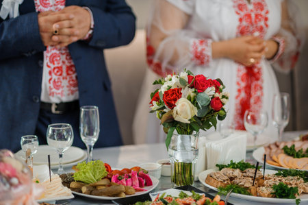 Elegant Table Setting at a Traditional Celebration with Floral Centerpiece and Elaborate Dishes.の写真素材