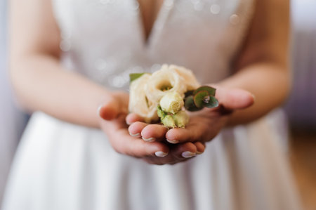 A Bride Holding a Delicate Wedding Boutonniの写真素材