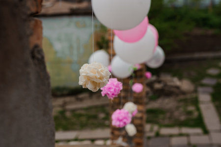 Elegant Decorative Display of Hanging Flowers and Balloons in a Garden Setting.の写真素材
