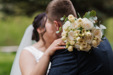 Romantic Wedding Embrace with Floral Bouquet.の写真素材