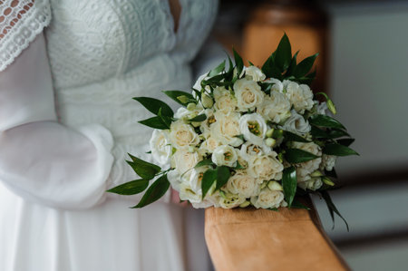 Elegant White Floral Bouquet Held by Bride in Bridal Attire.の写真素材
