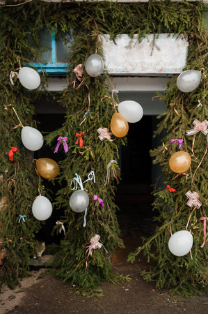 Festive Entrance Decorated with Balloons and Natural Greenery.