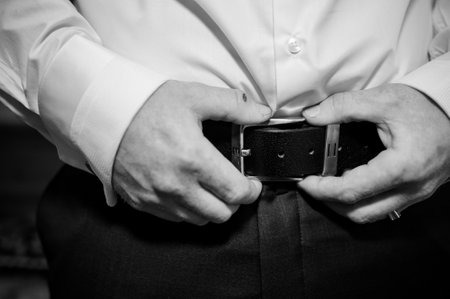 Groom Getting Ready: A Close-Up of Formal Attire Preparation.の写真素材
