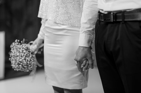 Elegant Couple Holding Hands at Their Wedding Ceremony.