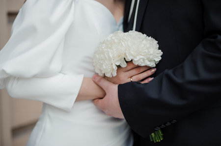 Romantic Wedding Moment with Bride and Groom Holding Hands.の写真素材