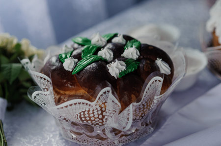 Decorative Bread with Greenery and Whipped Cream Garnish on Elegant Table Setting.