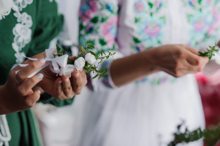 Traditional Floral Wreath Making Ceremony with Elegant Attire.の写真素材