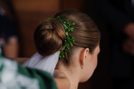 Elegant Bride with Floral Hairpiece and Classic Bun Hairstyle.