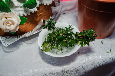 Fresh Herbal Arrangement in a Decorative Bowl Surrounded by Cultural Elements.の写真素材