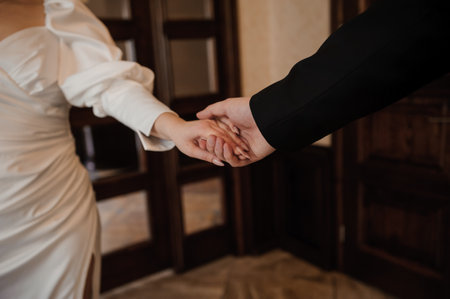Intimate Moment Between Bride and Groom Holding Hands.の写真素材