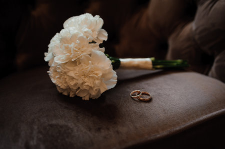 Elegant Wedding Bouquet with Rings on Soft Velvet Surface.の写真素材