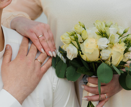 Intimate Wedding Moment with Elegant Floral Bouquet and Loving Hands.の写真素材