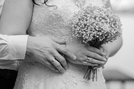 Intimate Moment of Newlyweds Embracing with Bouquet.の写真素材