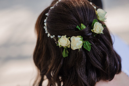 Elegant Floral Hairpiece Adorning a Bride's Hair at Outdoor Ceremony.