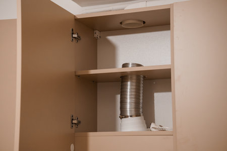 Interior View of a Kitchen Cabinet Featuring a Ventilation Duct.の写真素材