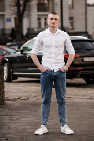 Stylish Young Man Posing Confidently in Urban Setting.の写真素材