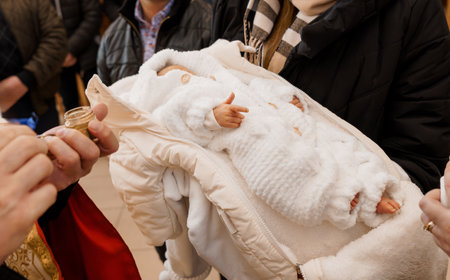 Infant in White Blanket at a Ceremony.