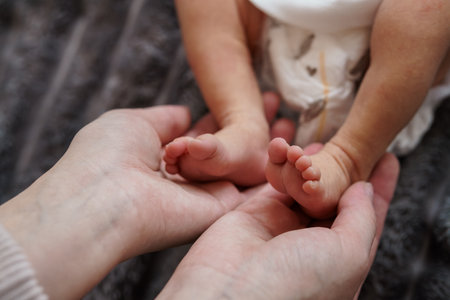 Tender Moment: A Parent's Hands Gently Cradling a Baby's Tiny Feet.