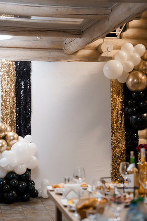 Elegant Party Setup with Gold, Black, and White Balloons and Sequined Decor.