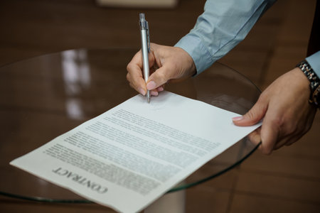 Signing a Legal Contract with Confidence in a Modern Office Setting.の写真素材