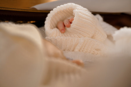 Softly Wrapped Infant Hand in Cozy Knitwear.