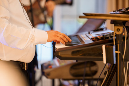 Professional Keyboardist Performing Live Music on Stage with Illuminated Instrument. Vibrant White...