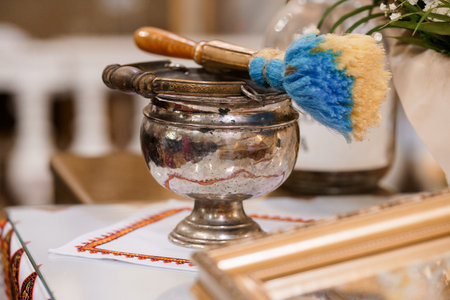 A close-up showcases a traditional Tibetan singing bowl with a wooden mallet and blue brush, embodying spiritual practice, meditation, and peaceful ambianceの写真素材