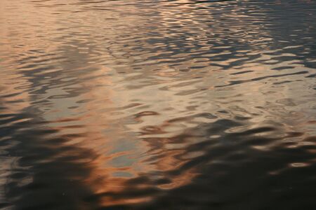 Water surface at sunsetの写真素材