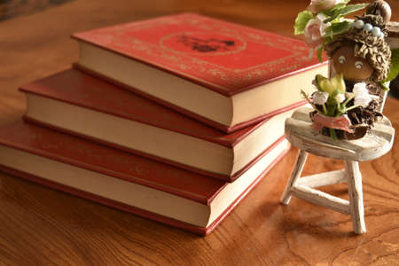Book with a red cover three books with a toy man