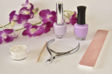 Manicure or pedicure tools on white with Orchidの写真素材