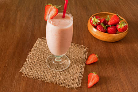 Strawberry healthy milkshake on wooden blackground. Strawberry Helthy Smoothie.の写真素材