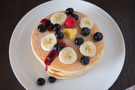 Delicious pancakes with blueberry and bananas on white plateの写真素材