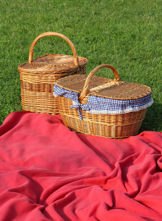 Picnic baskets and blankets in the grass.の写真素材