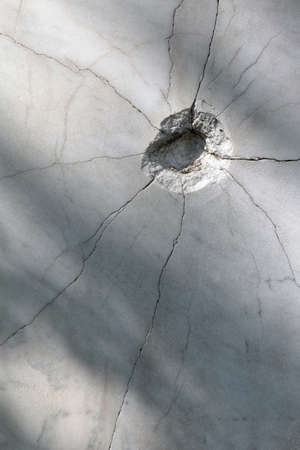 shot hole pressure cracked the marble surface.の写真素材