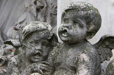 Two angels carved stone sculpture.の写真素材