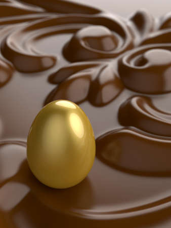 An Easter golden egg with chocolate ornament in front.の写真素材