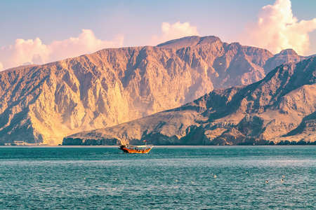 Sea, pleasure boats, rocky shores in the fjords of the Gulf of Oman