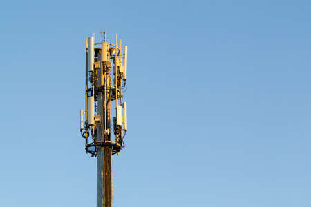 top of telecommunication tower against blue sky