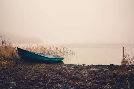Fishing boat on the lake in the fog